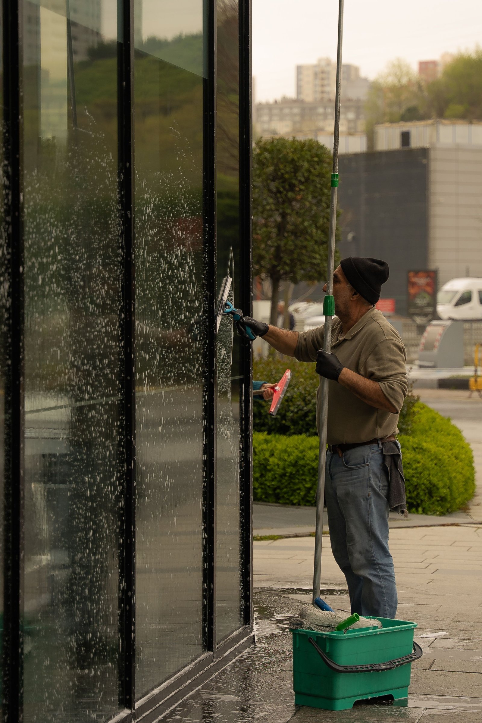 Cleaner washing exterior glass of a commercial building
